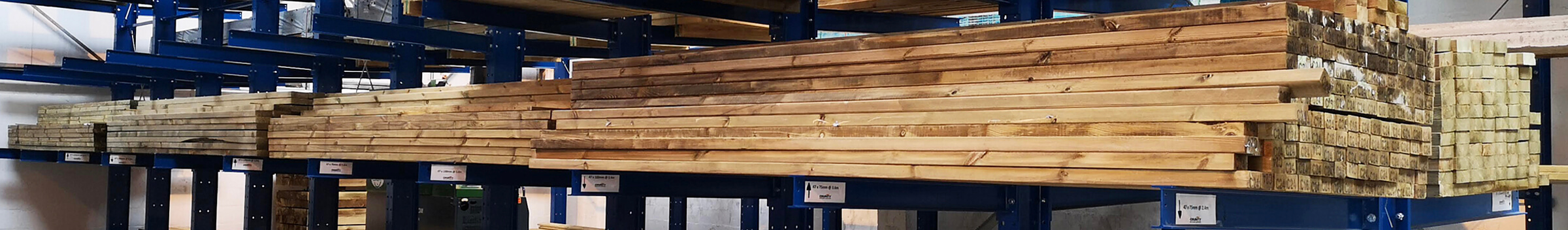 Stacks of timber stored on metal shelving in a warehouse